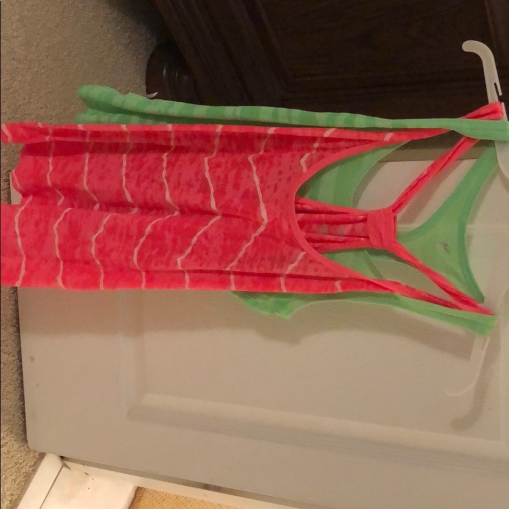 Green and pink gym tanks